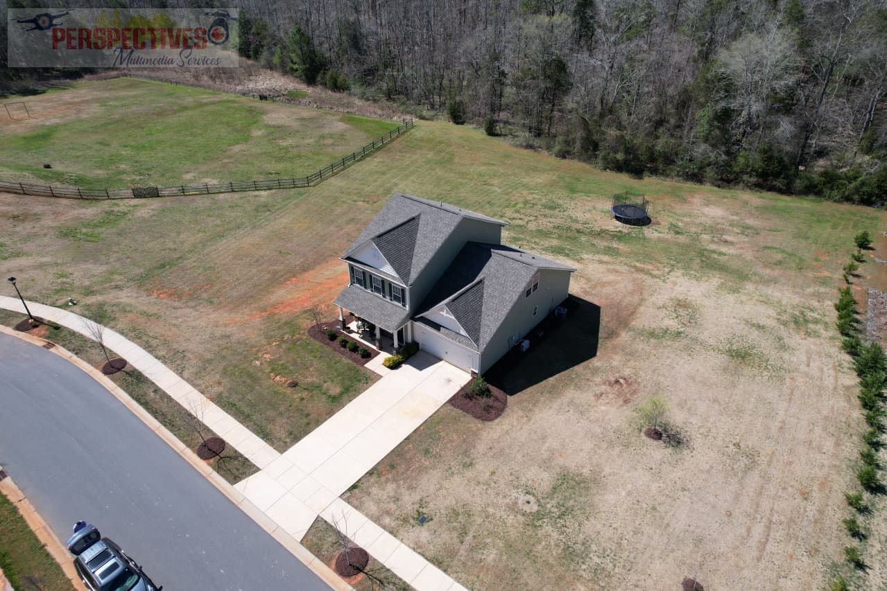 A house with a driveway and grass field.