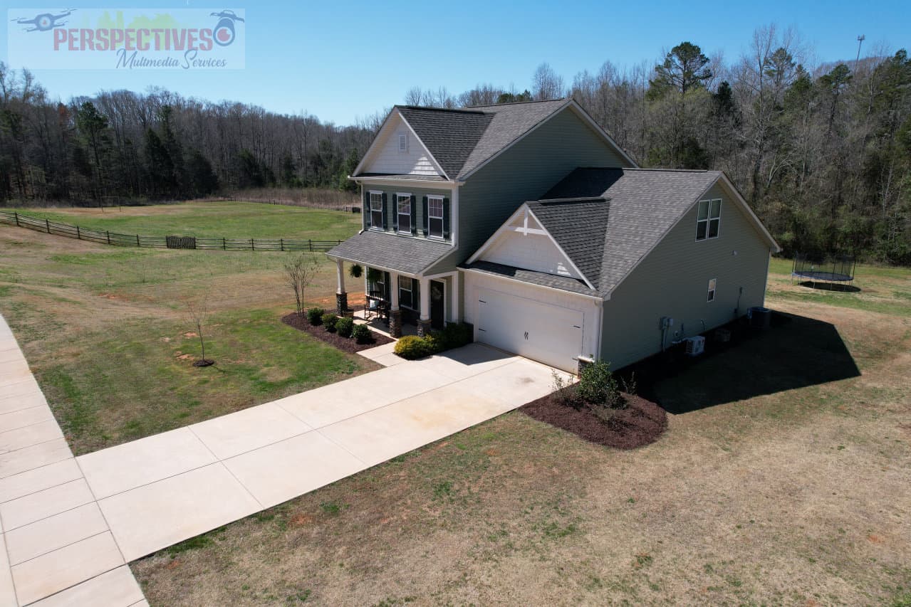 A house with a driveway and grass.