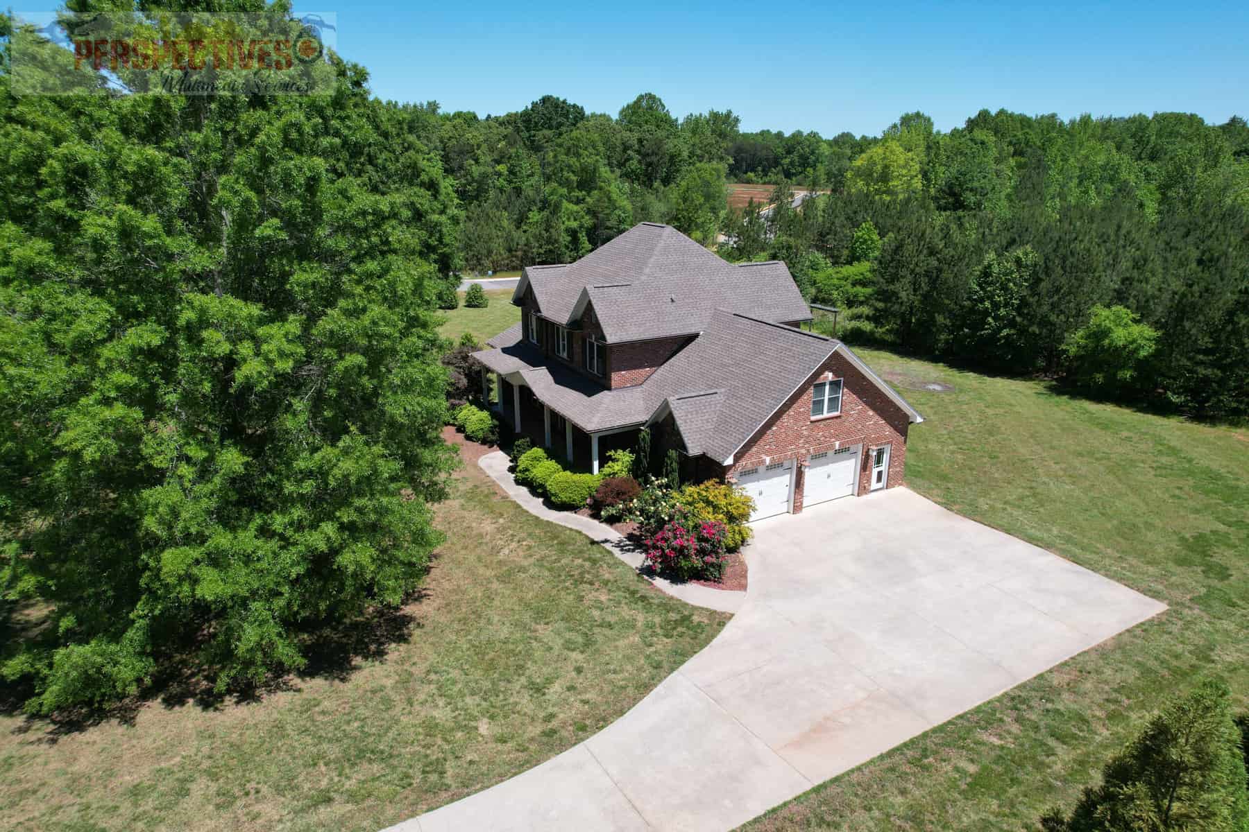 A house with a driveway and trees.