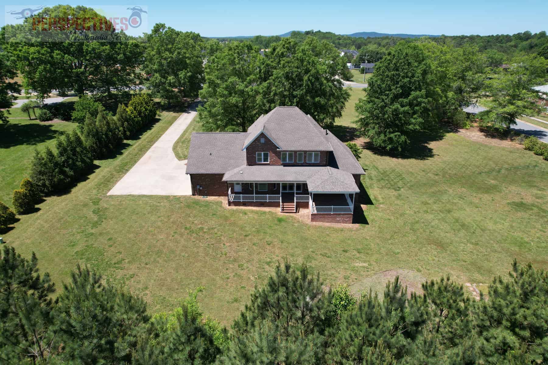 A house with a driveway and trees.