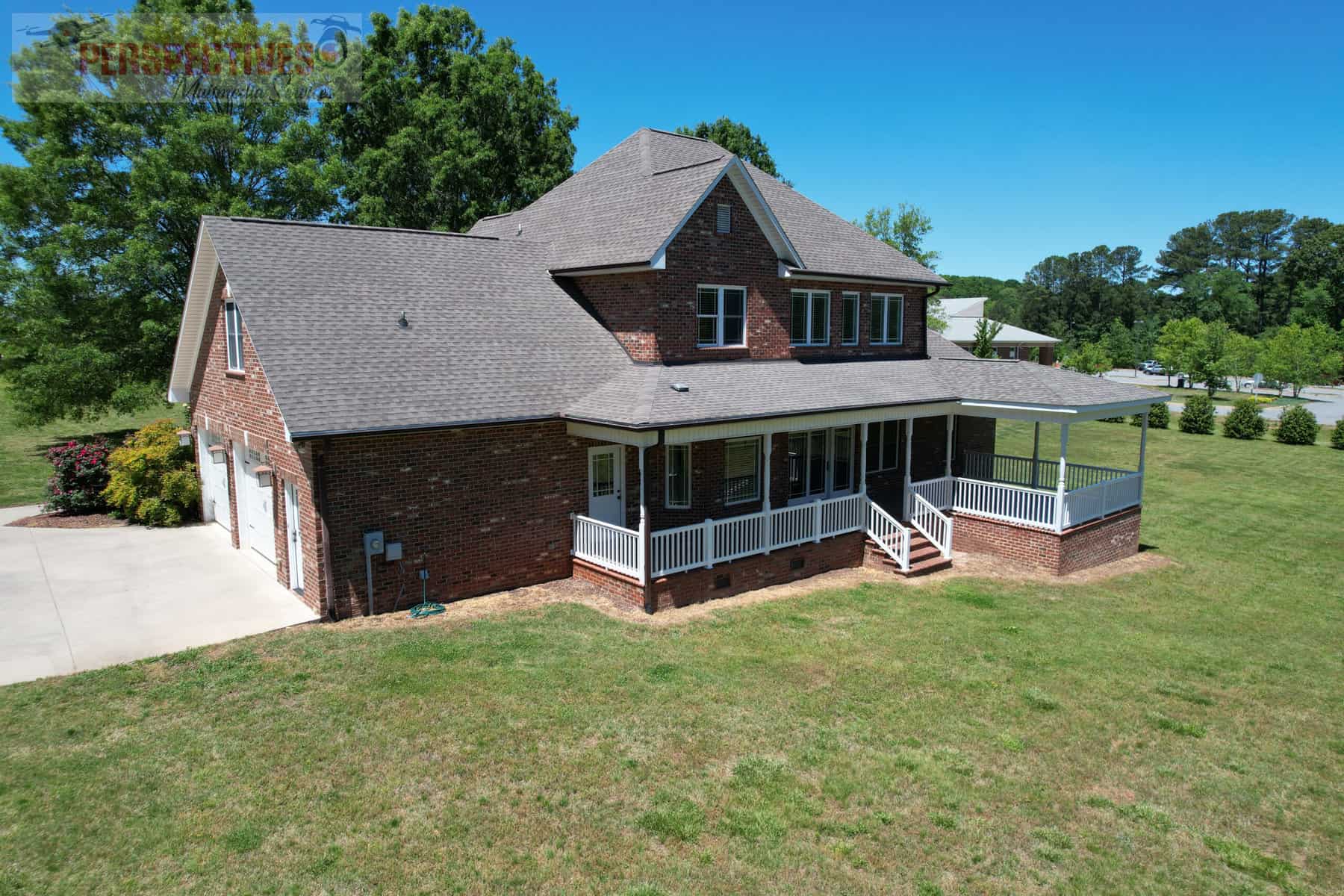 A house with a porch and a lawn.