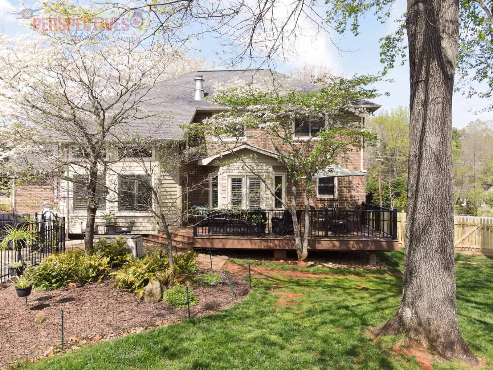 A house with a fence and trees.