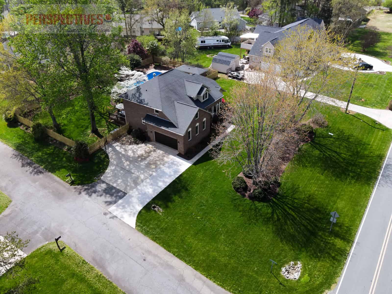 A house with a pool in the middle of a neighborhood.