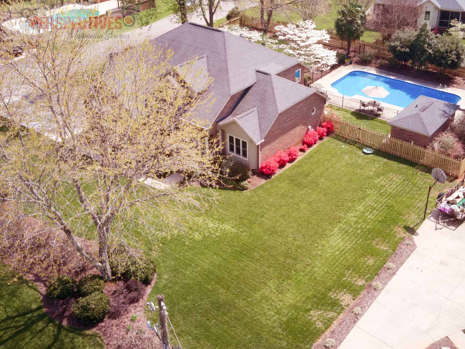 A house with a pool in the back yard.