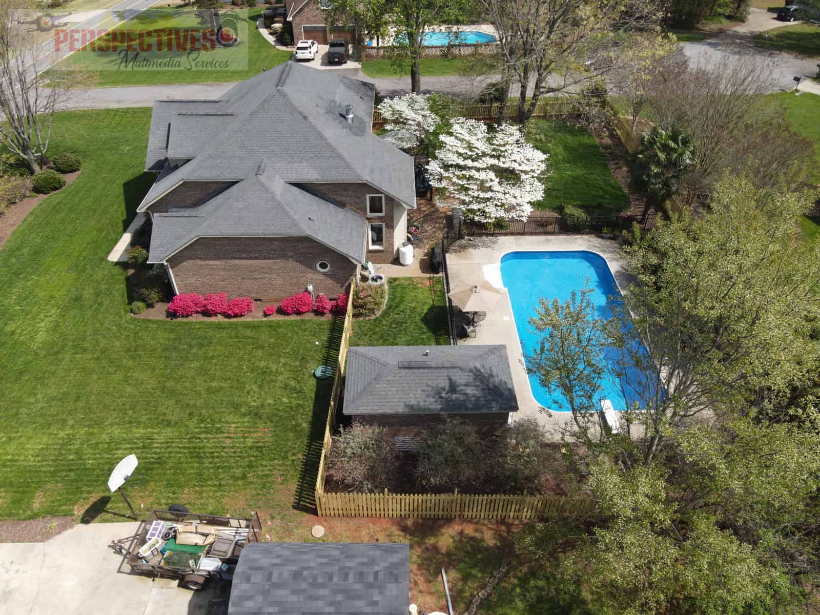 A house with a pool and a lawn.