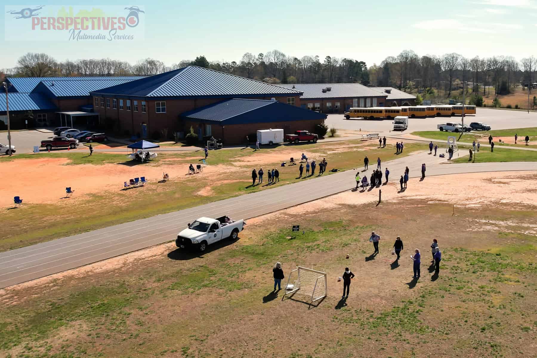 A group of people outside a school.