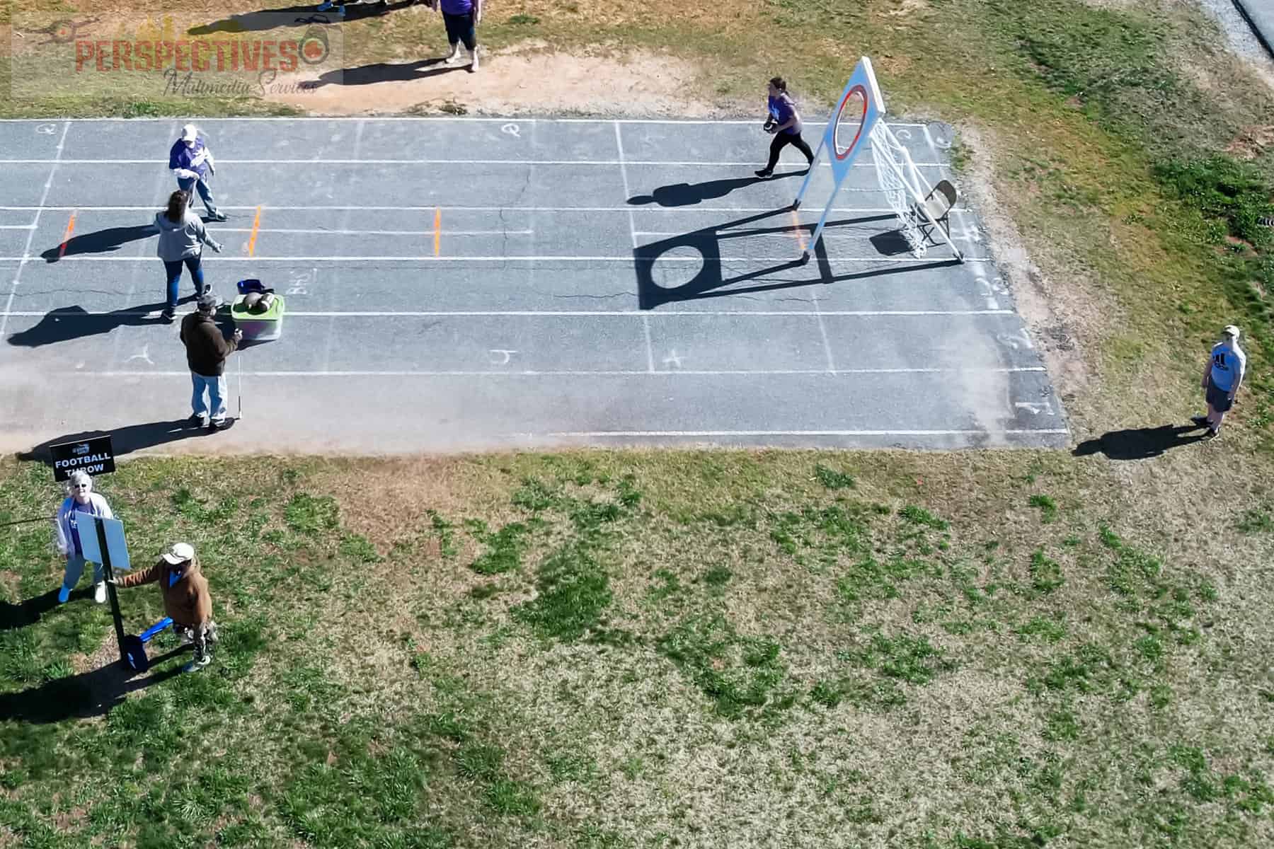 A group of people running on a track.