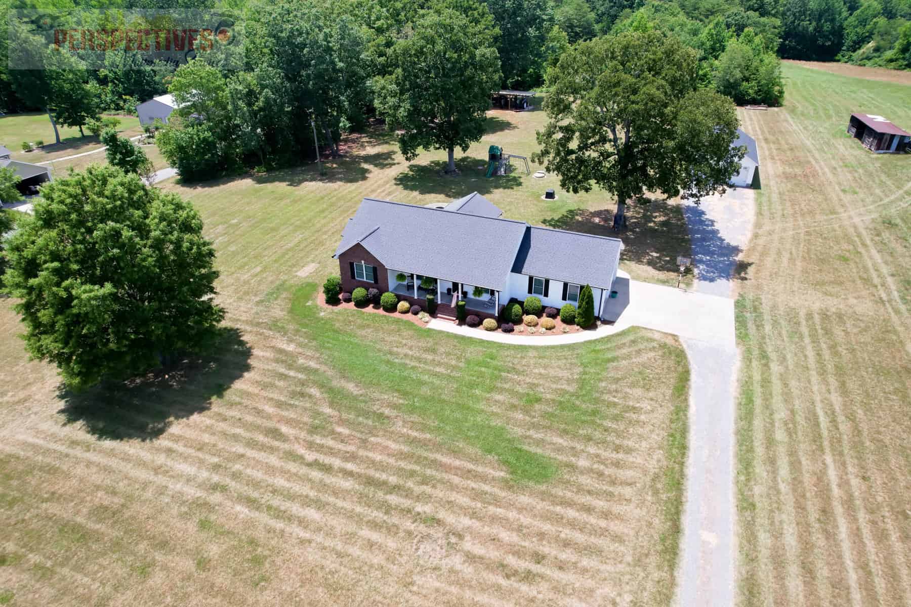 A house with a lawn and trees.