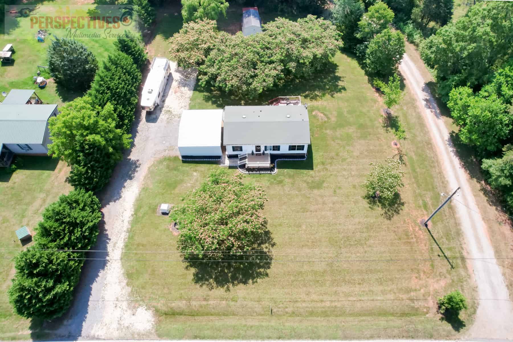 A house with a lawn and trees.