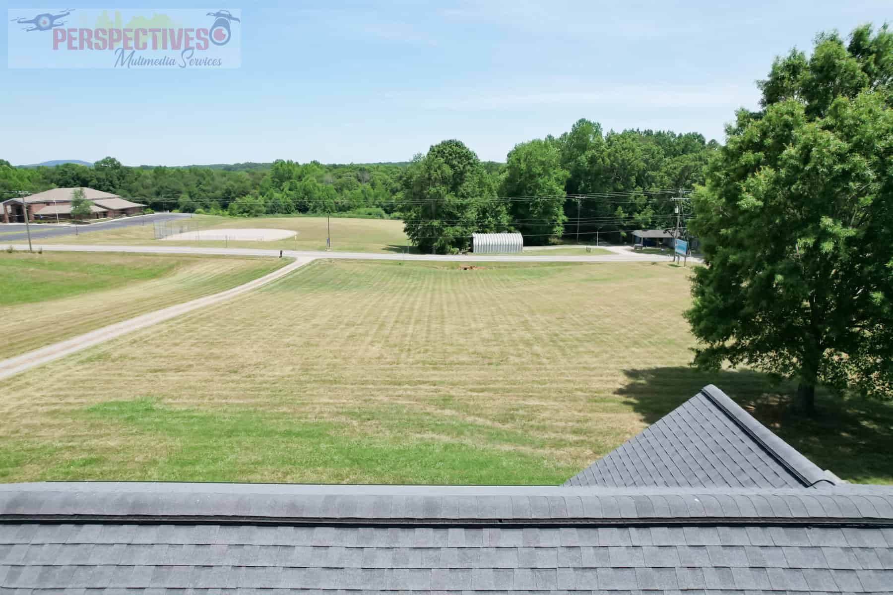 A view of a field from a roof.