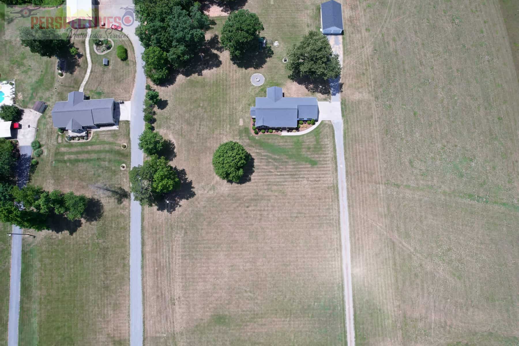 A bird's eye view of a house and a road.