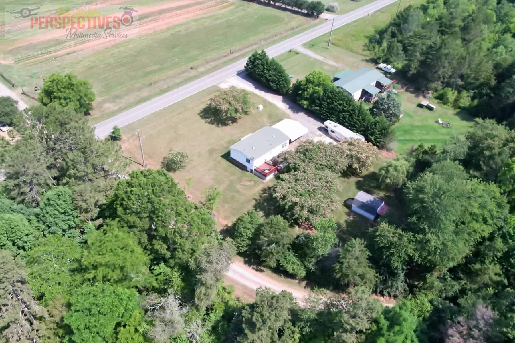 An aerial view of a house and a road.