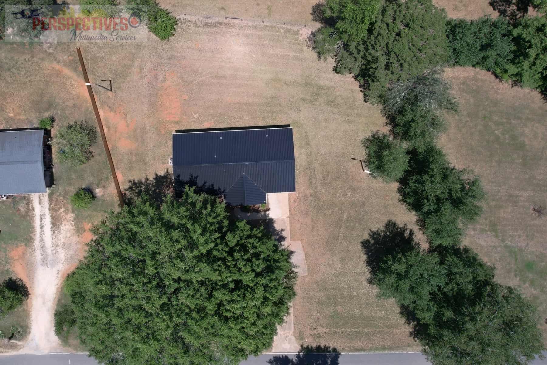 A house with trees and grass.