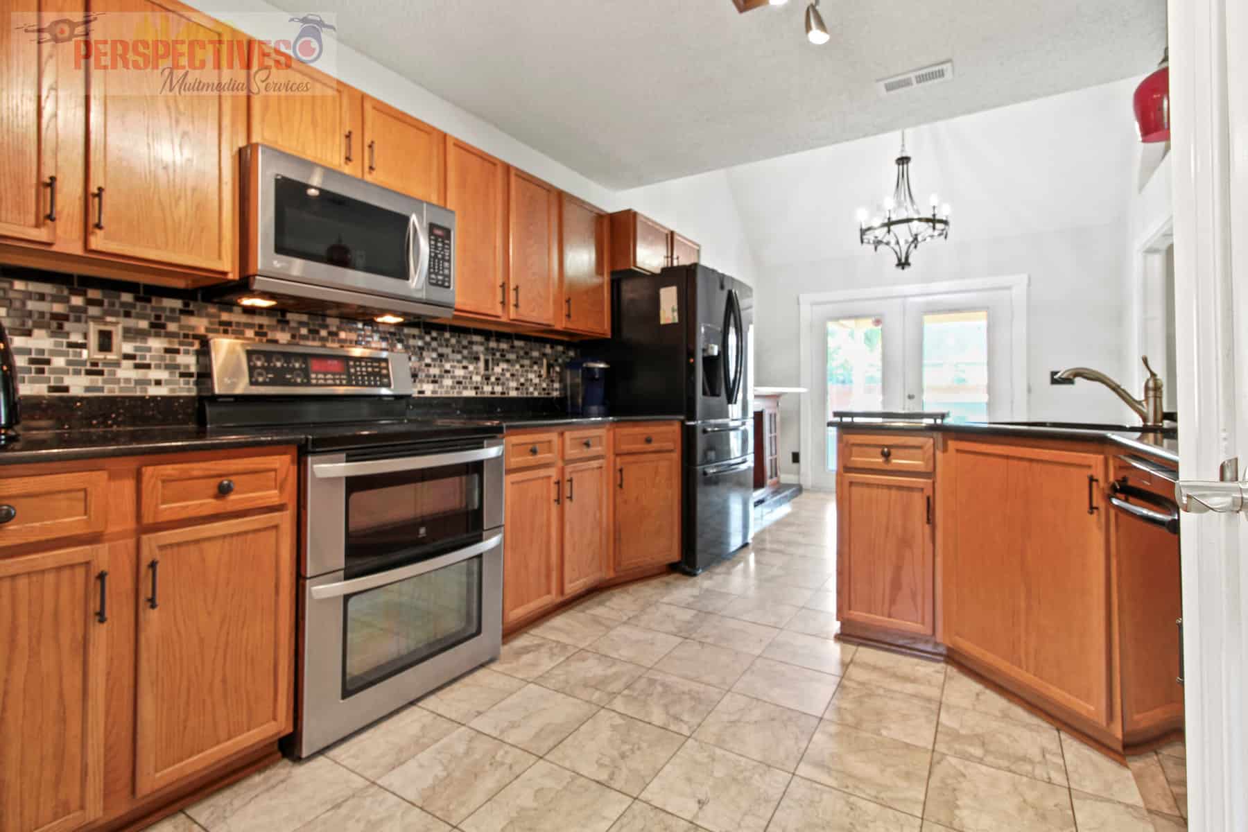 A kitchen with wood cabinets and stainless steel appliances.