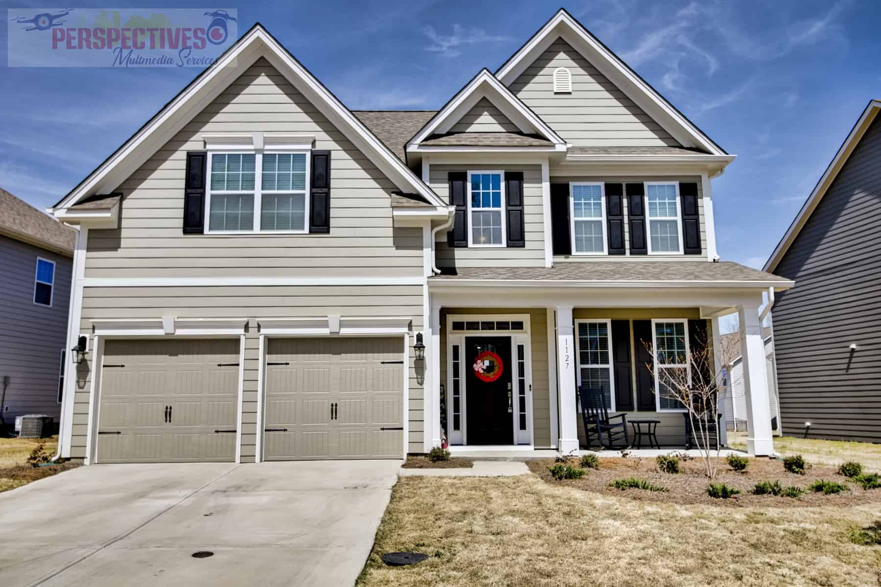 A home with two garages and a garage door.