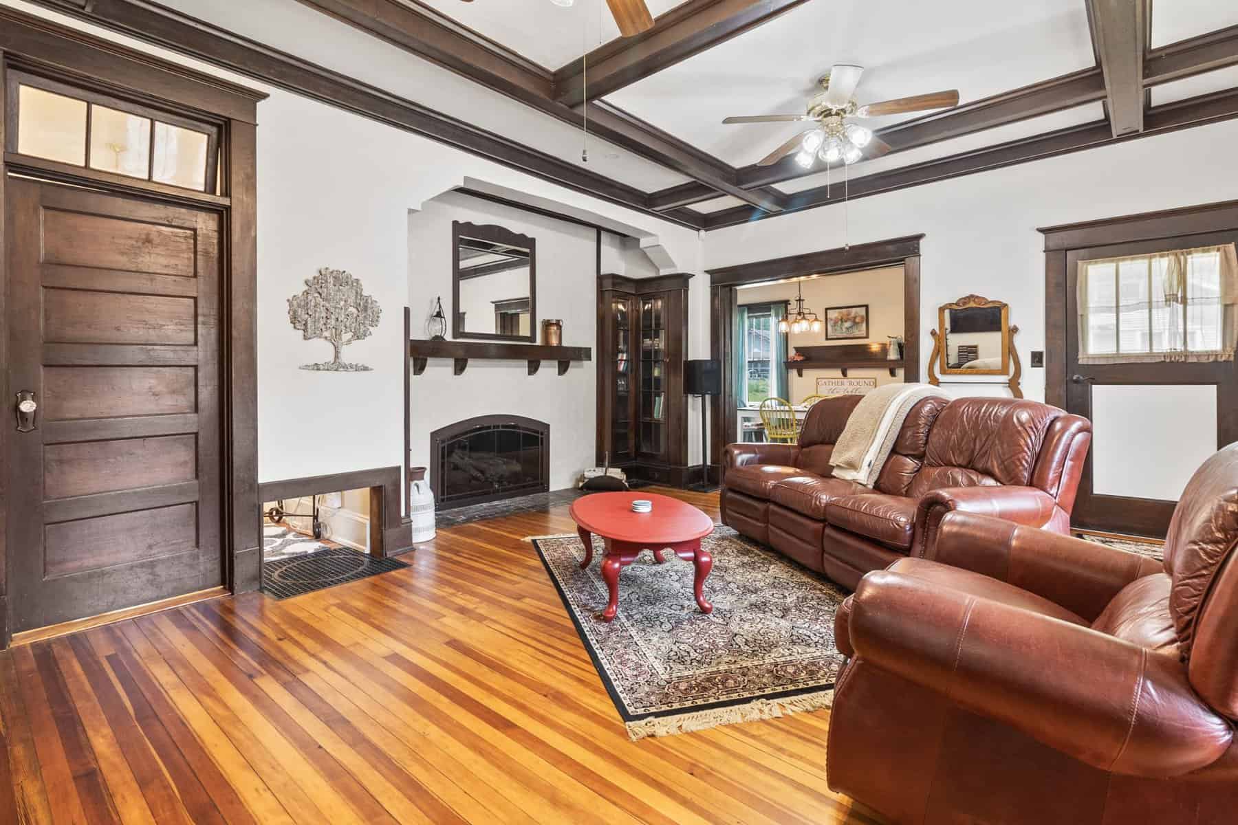 A living room with hardwood floors and a fireplace.