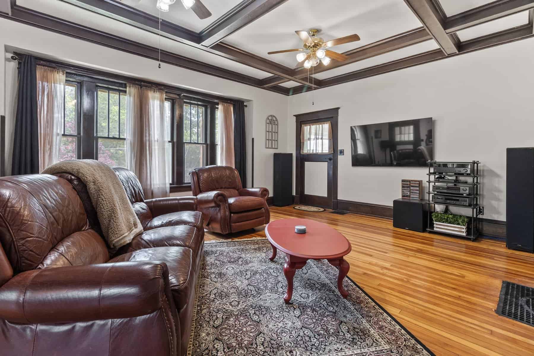 A living room with hardwood floors and wooden ceilings.