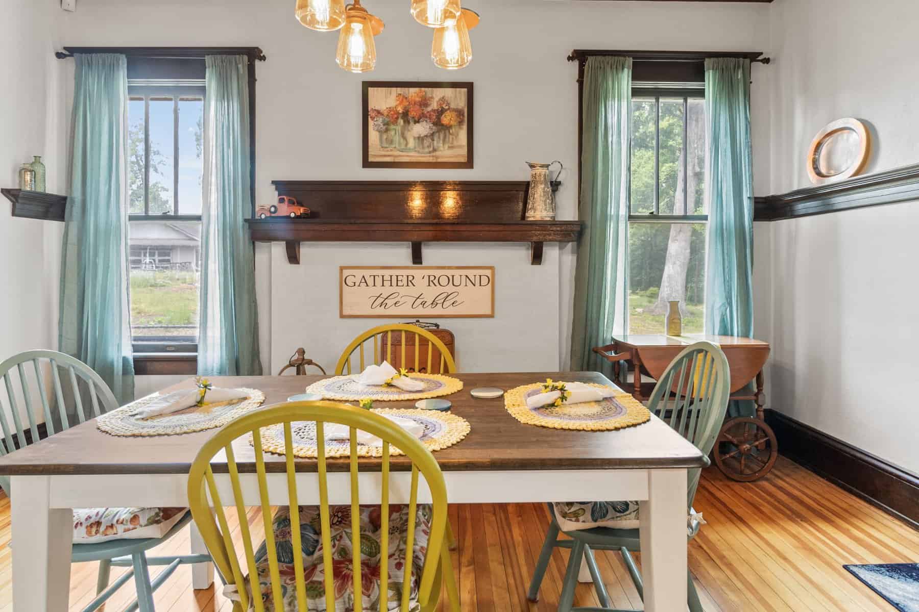 A dining room with a wooden table and chairs.