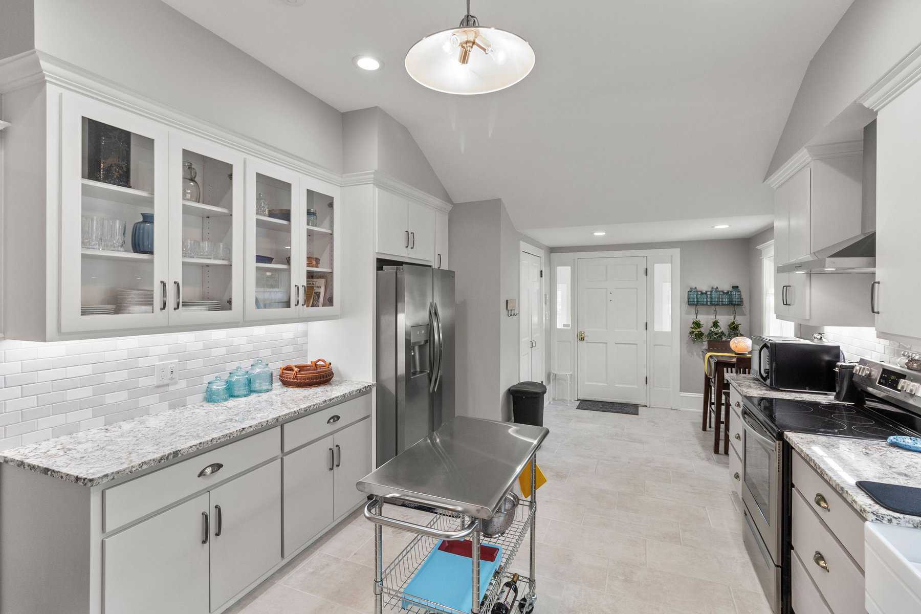 A kitchen with white cabinets and stainless steel appliances.