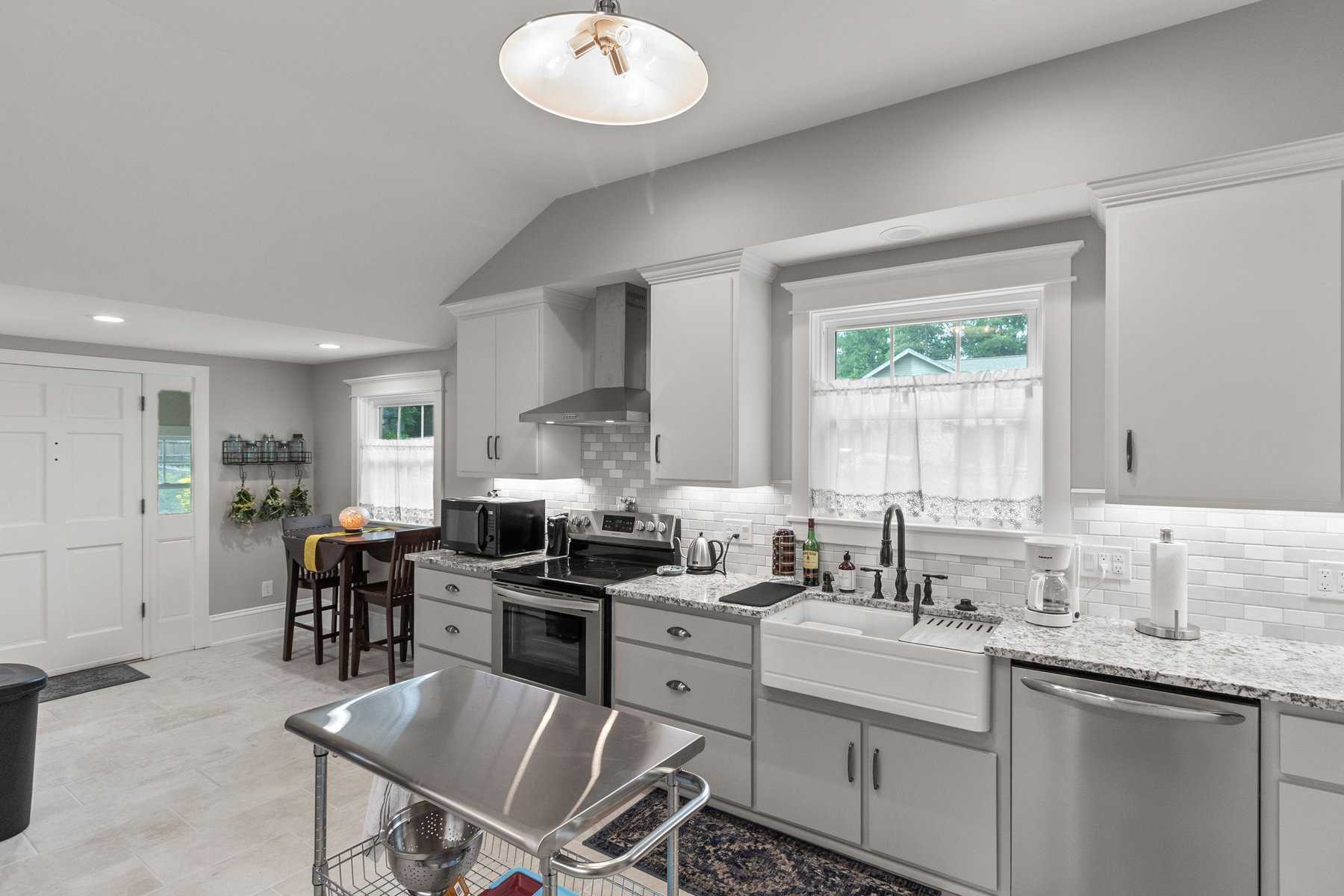 A kitchen with white cabinets and stainless steel appliances.