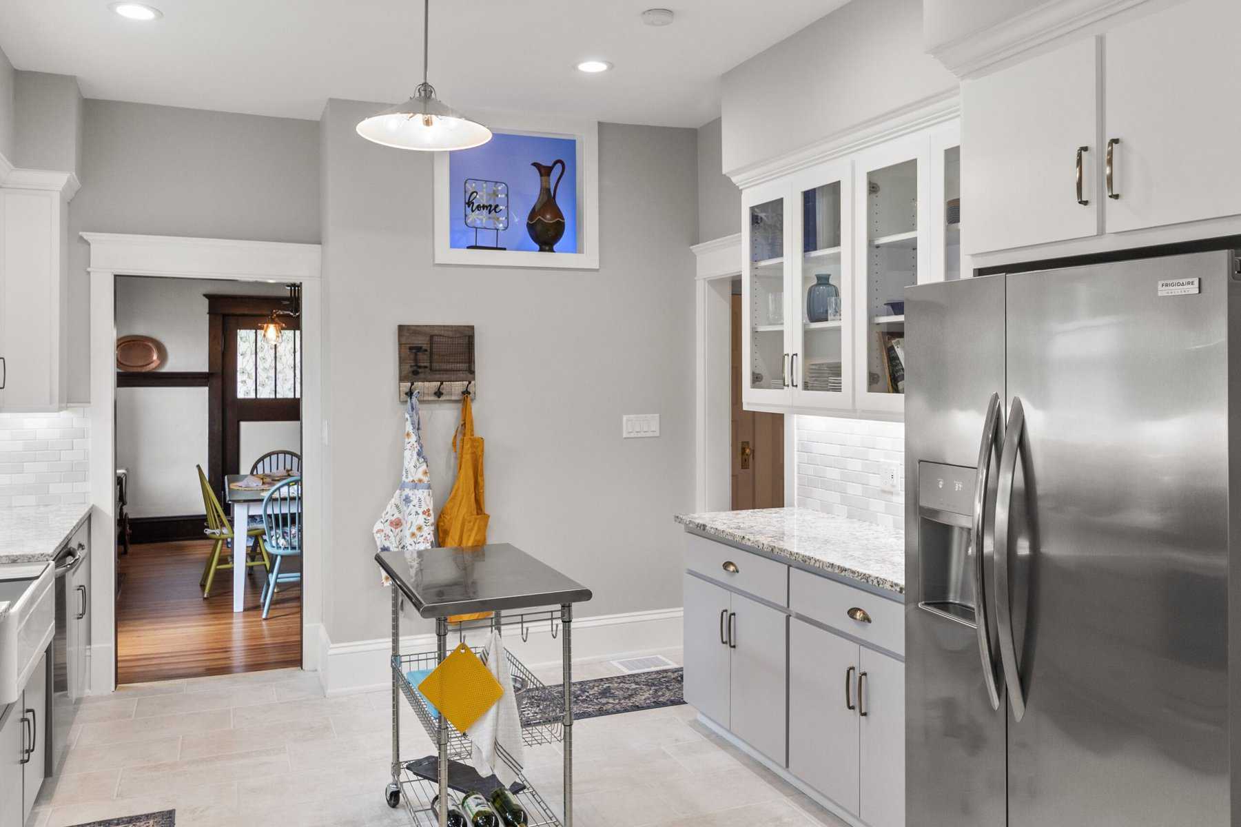 A kitchen with white cabinets and stainless steel appliances.