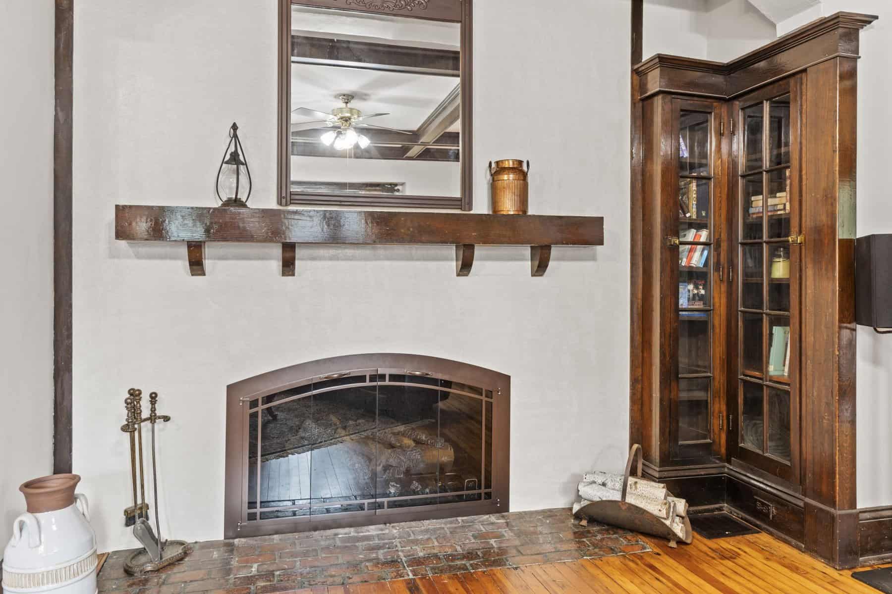 A living room with a fireplace and bookshelves.