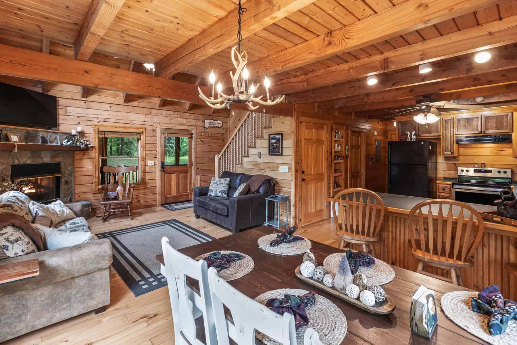 The living room and dining area of a log cabin.