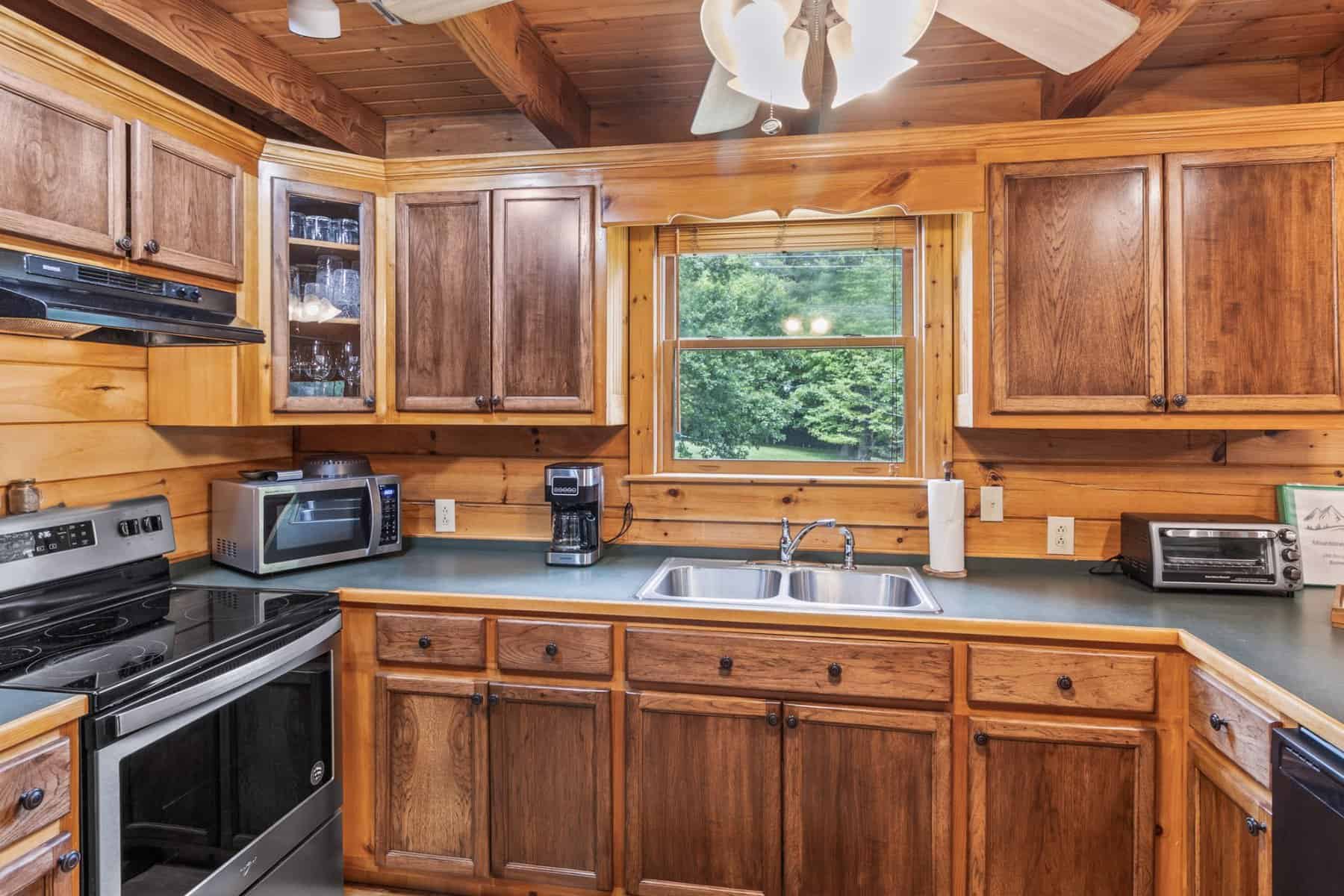 A kitchen with wood cabinets and a ceiling fan.