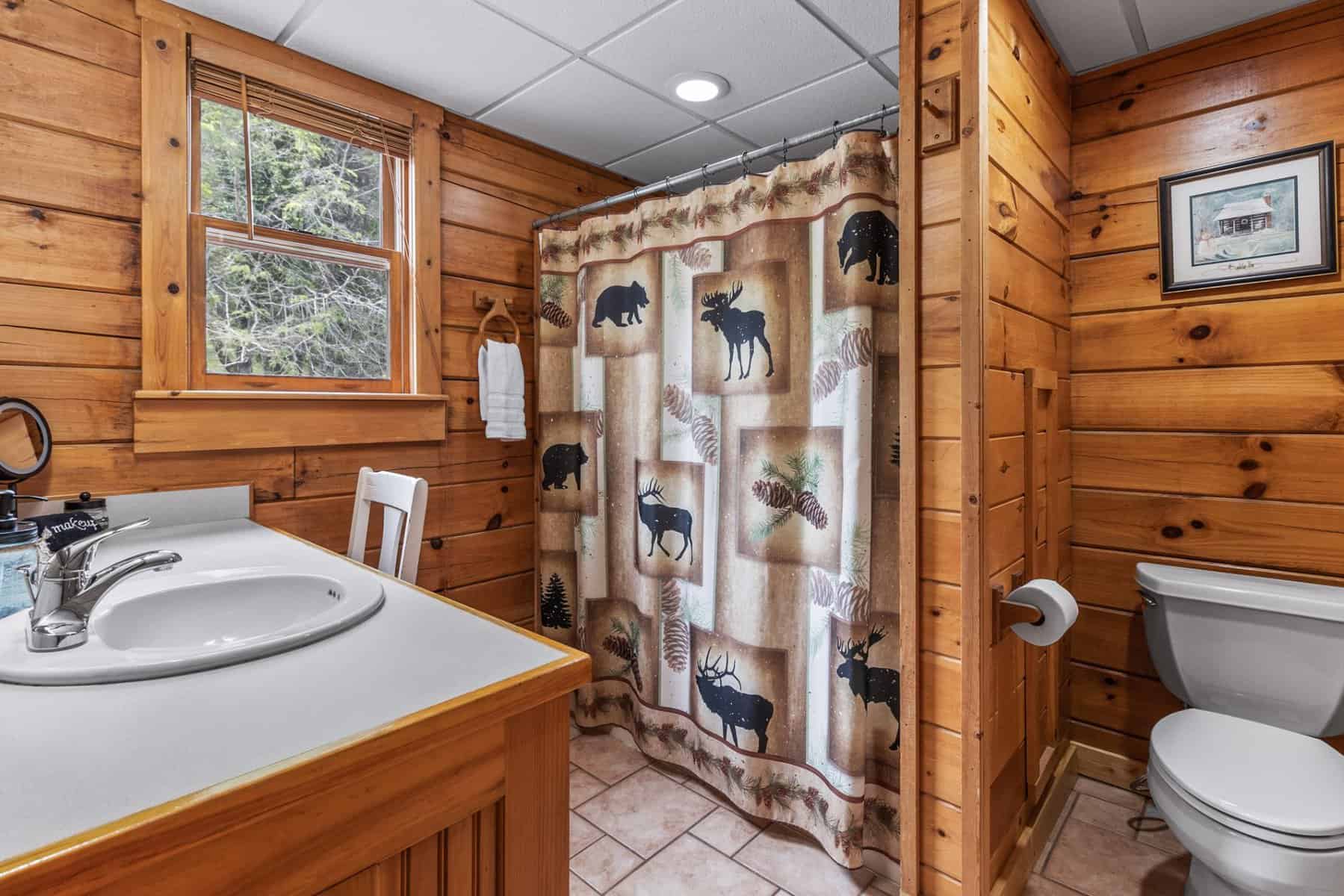 A bathroom with wood paneling and a toilet.