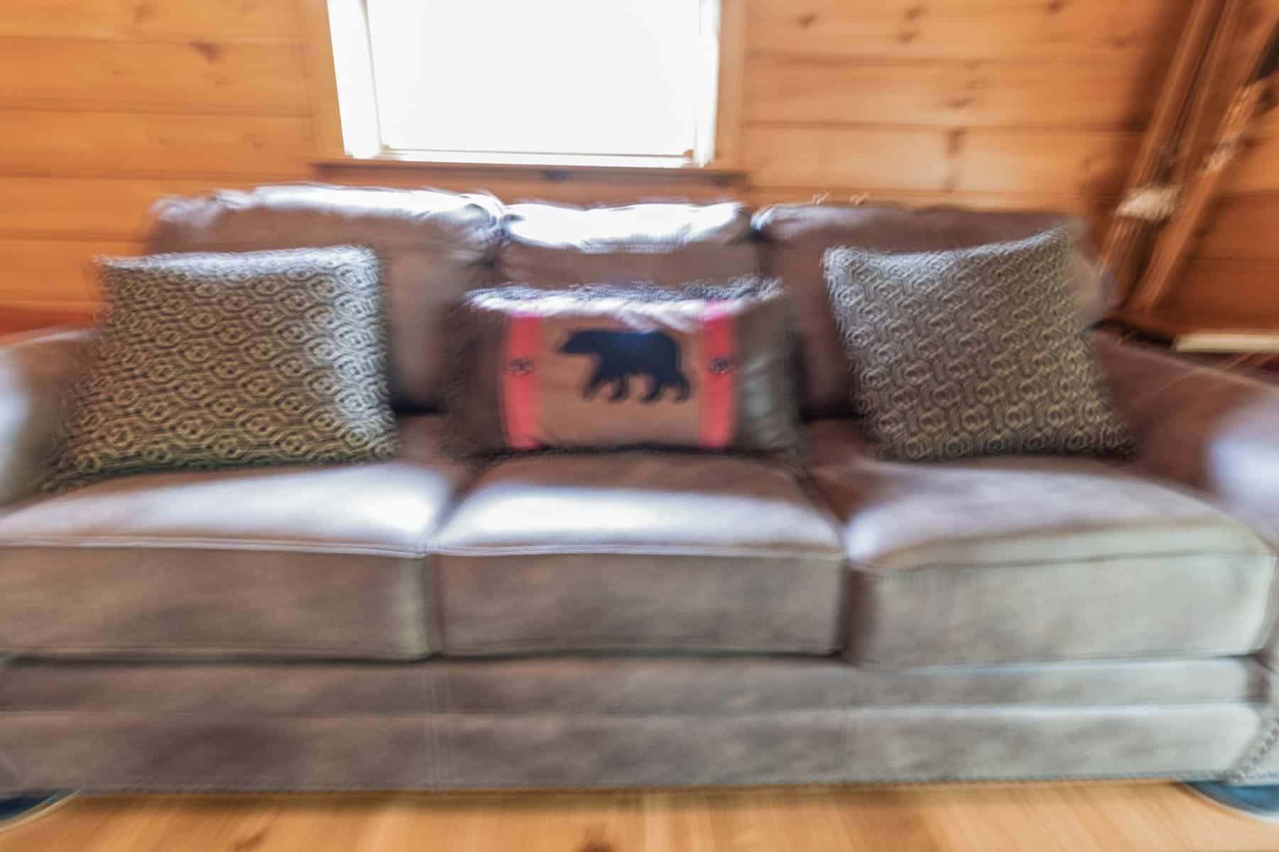 A gray couch in a cabin.