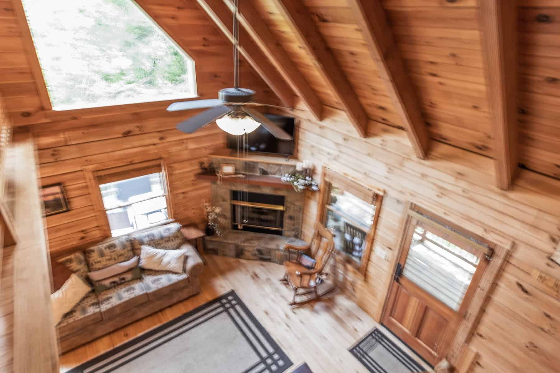 A view of the living room of a log cabin.