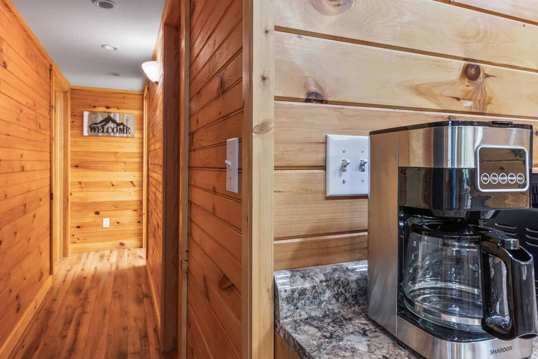 A coffee maker sits on a counter in a cabin.