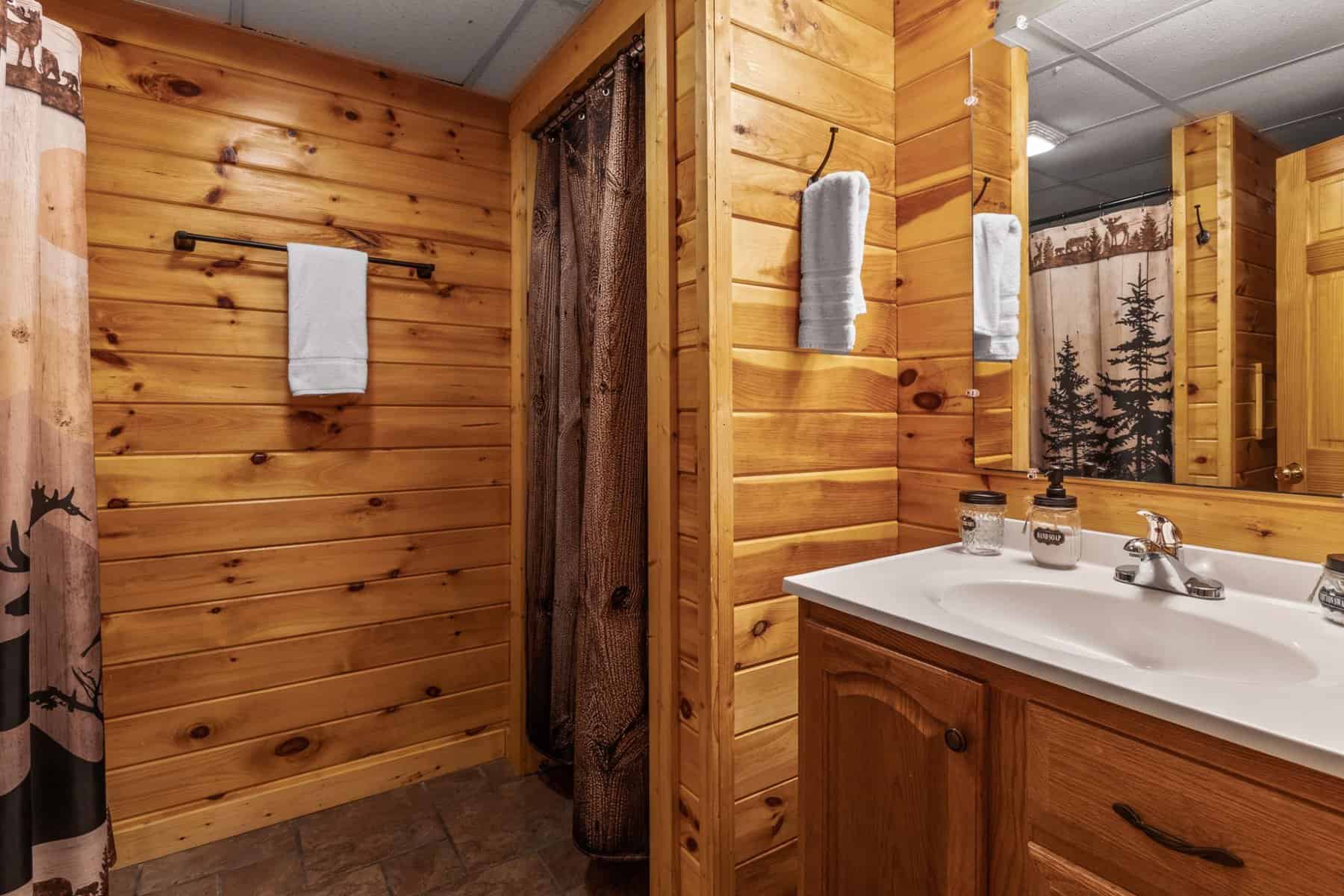 A bathroom with wood paneling and a sink.