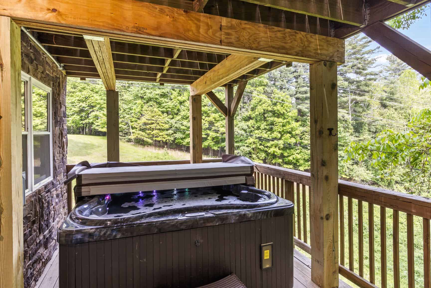 A hot tub on the deck of a cabin.