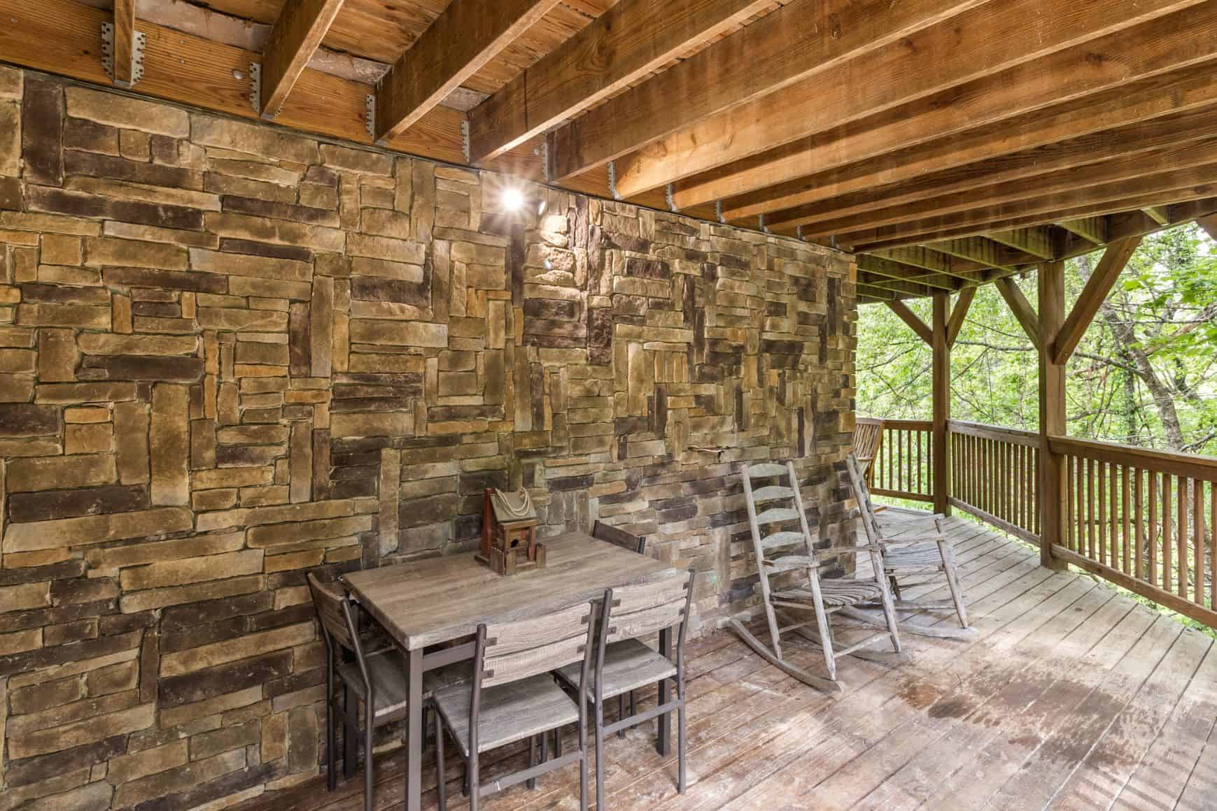 A wooden deck with a table and chairs.