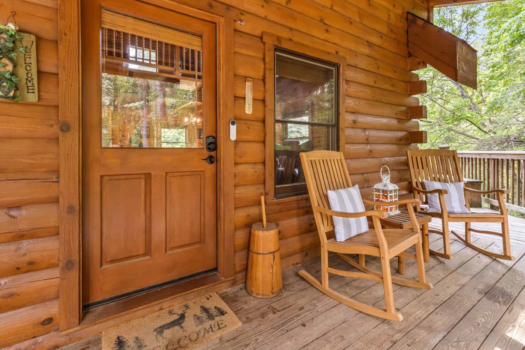 A rocking chair on the porch of a cabin in pigeon forge.