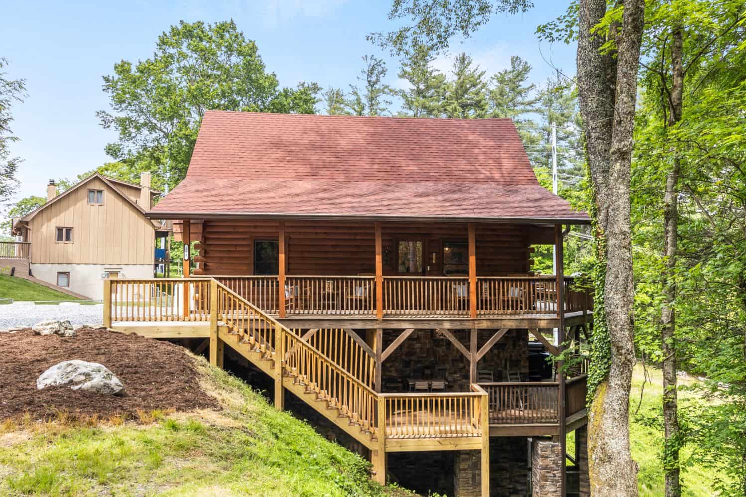 A cabin in the woods with stairs leading up to it.