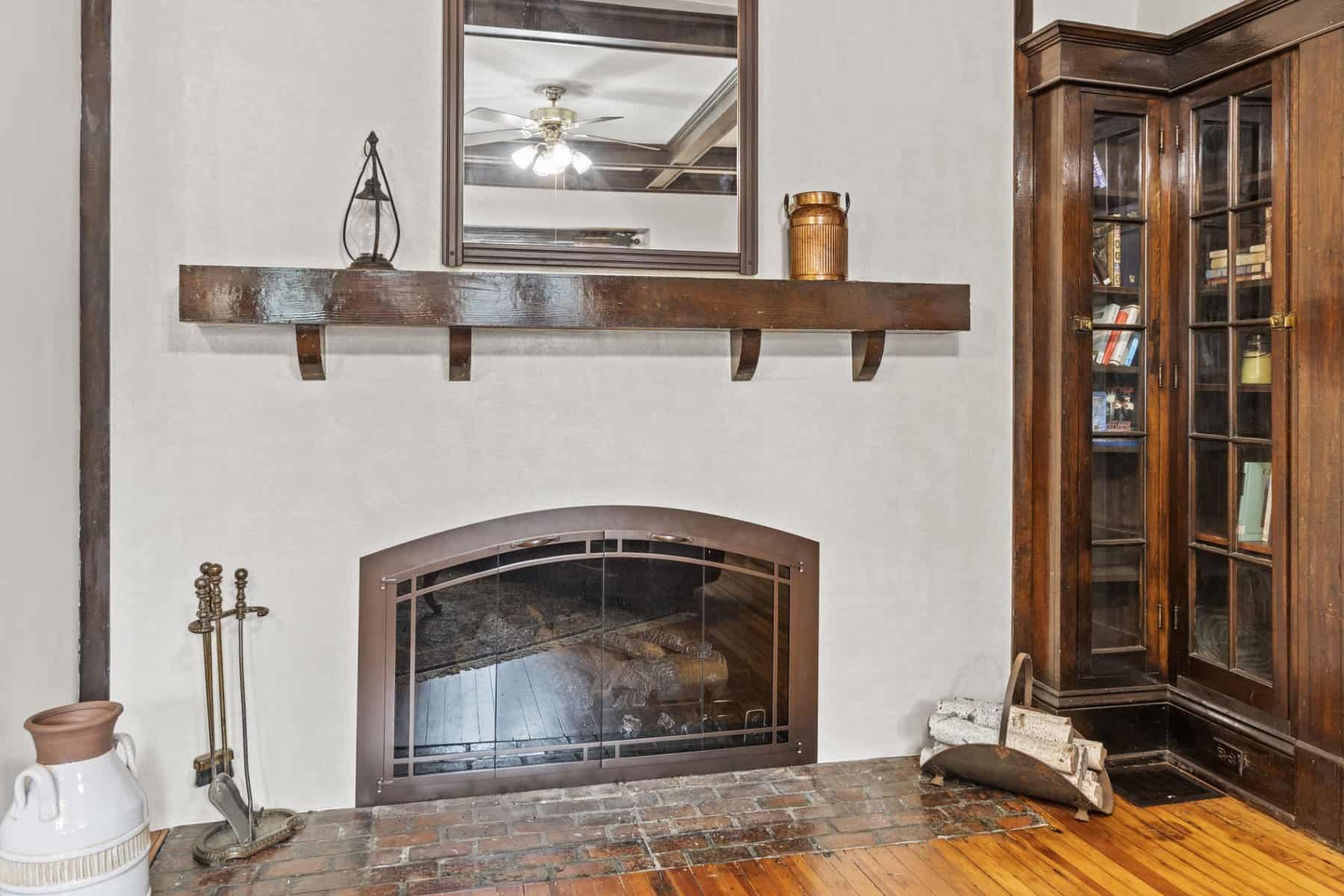 A living room with a fireplace and bookshelves.