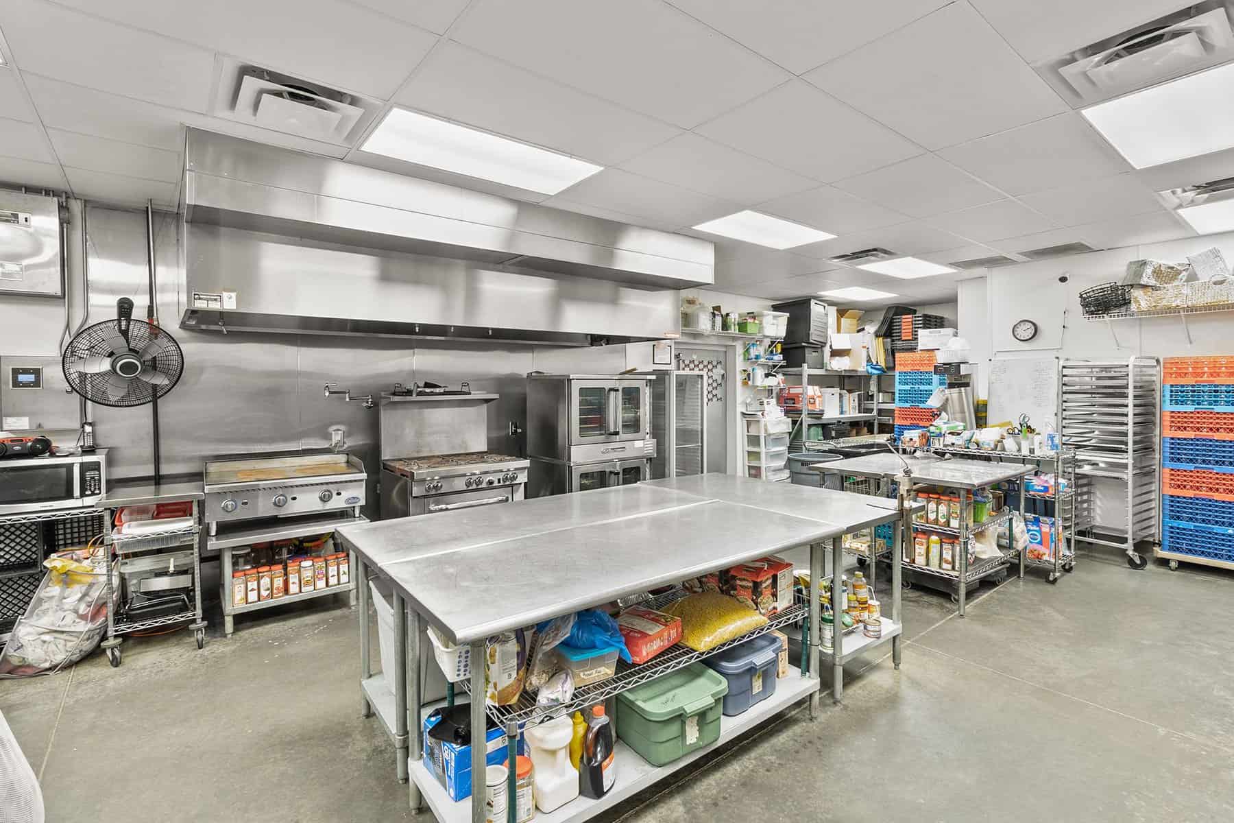 A large kitchen with lots of equipment and utensils.