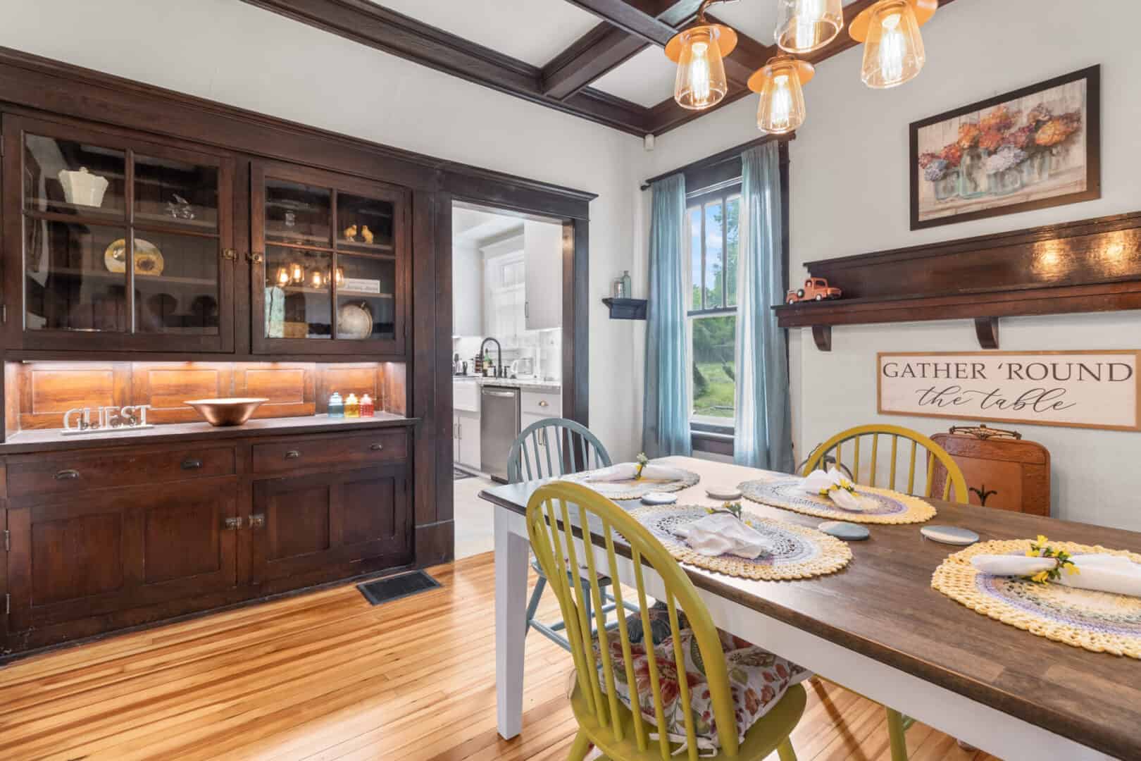 A dining room with a wooden table and chairs.