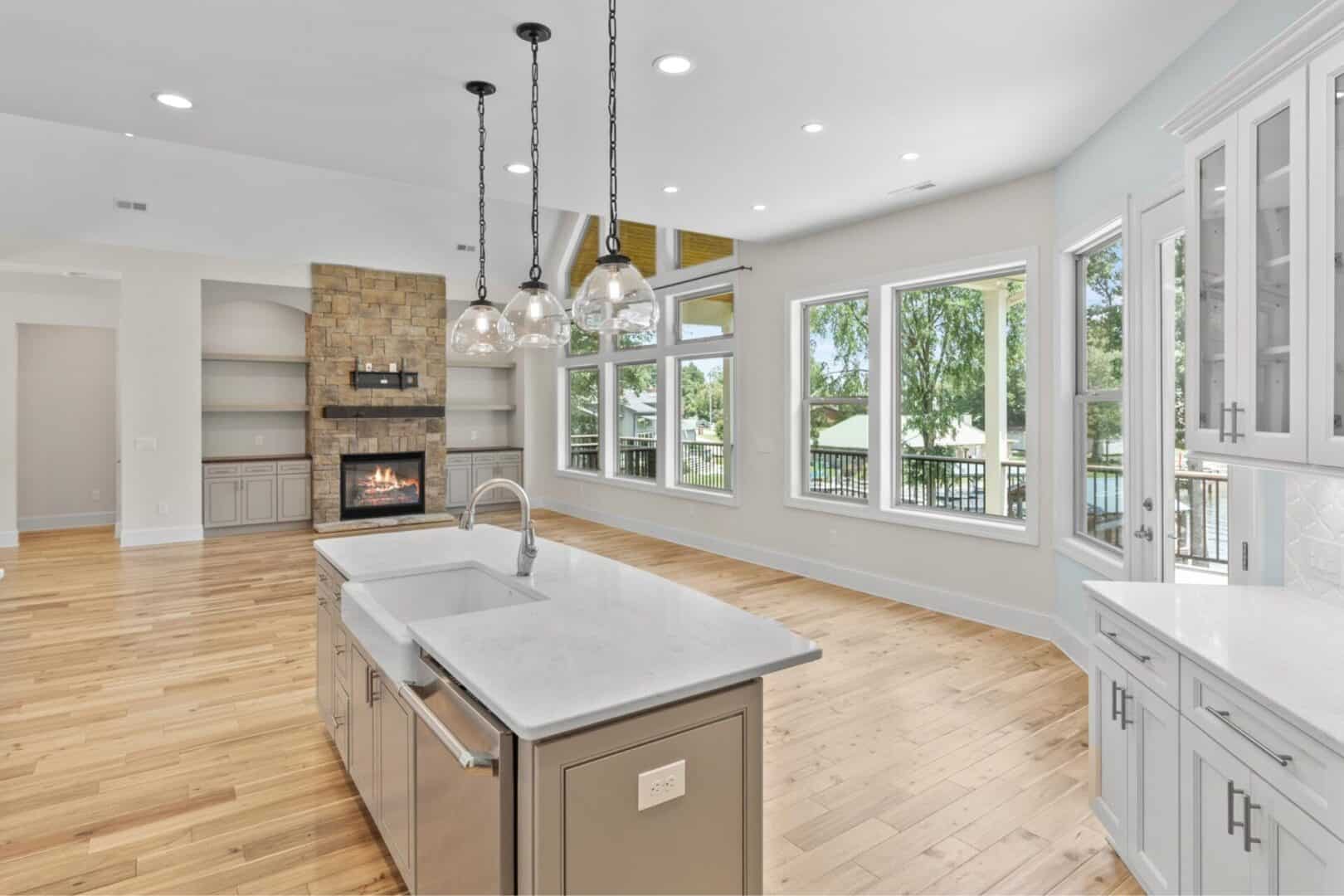 An open kitchen with hardwood floors and a fireplace.