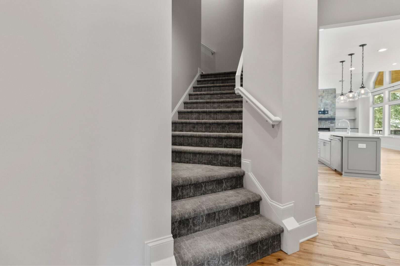 A staircase leading to a kitchen in a home.