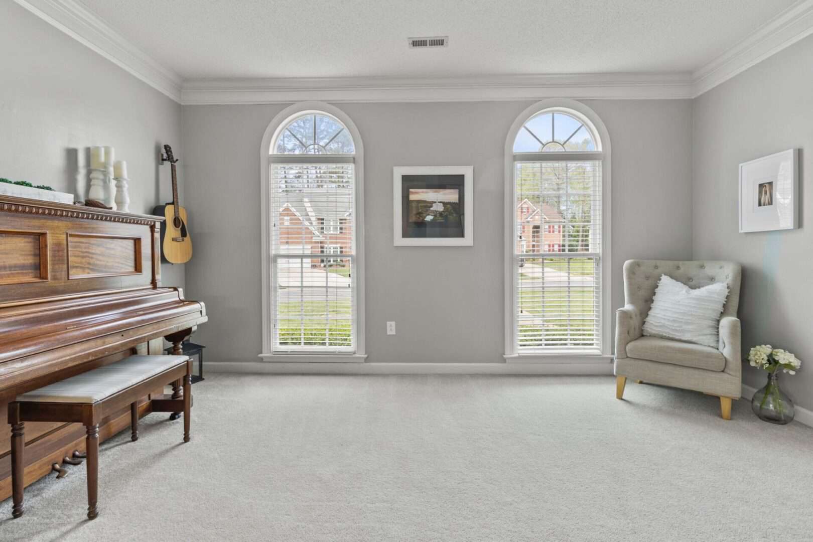 A living room with a piano and a guitar.