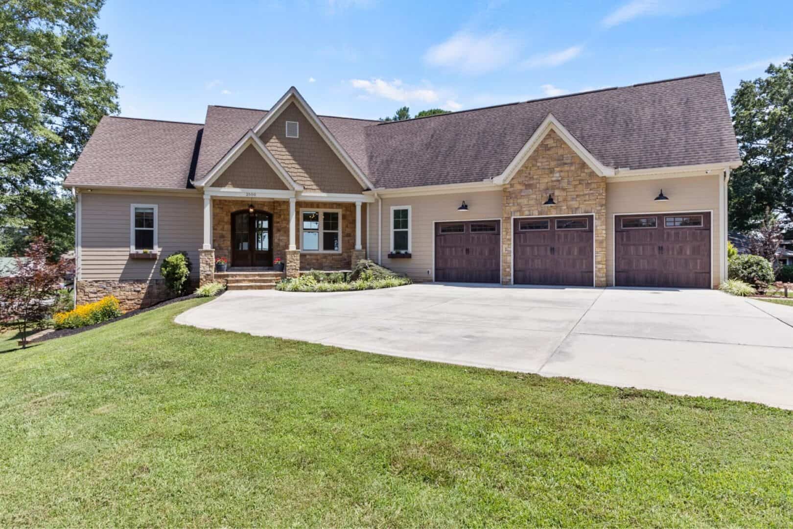 A home with two garages and a driveway.