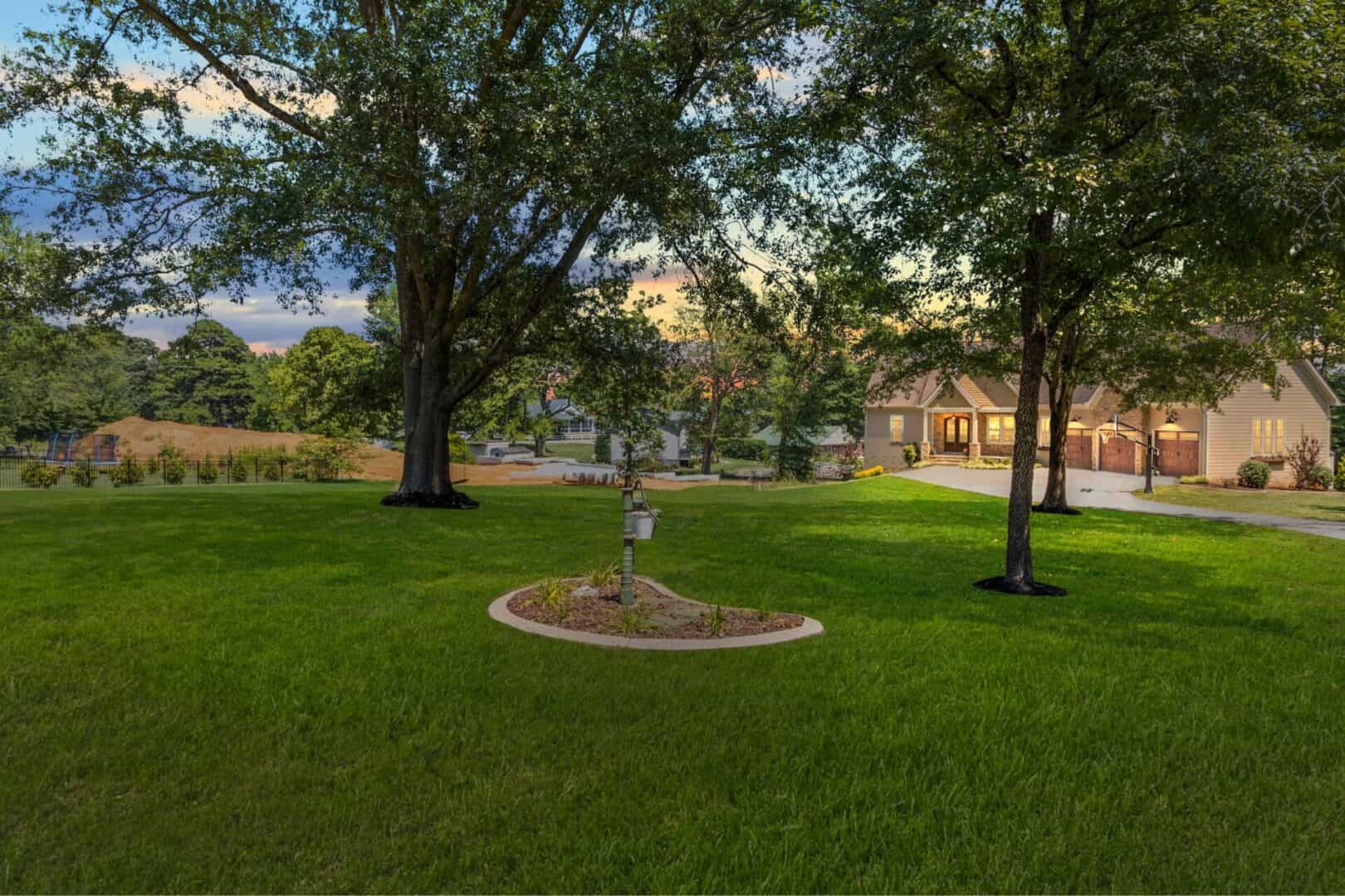 A home with a grassy yard and trees.