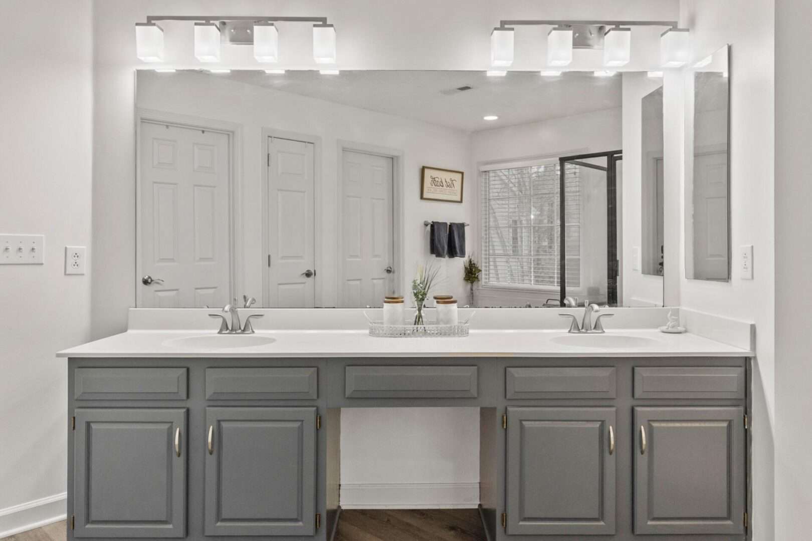 A bathroom with two sinks and a mirror.