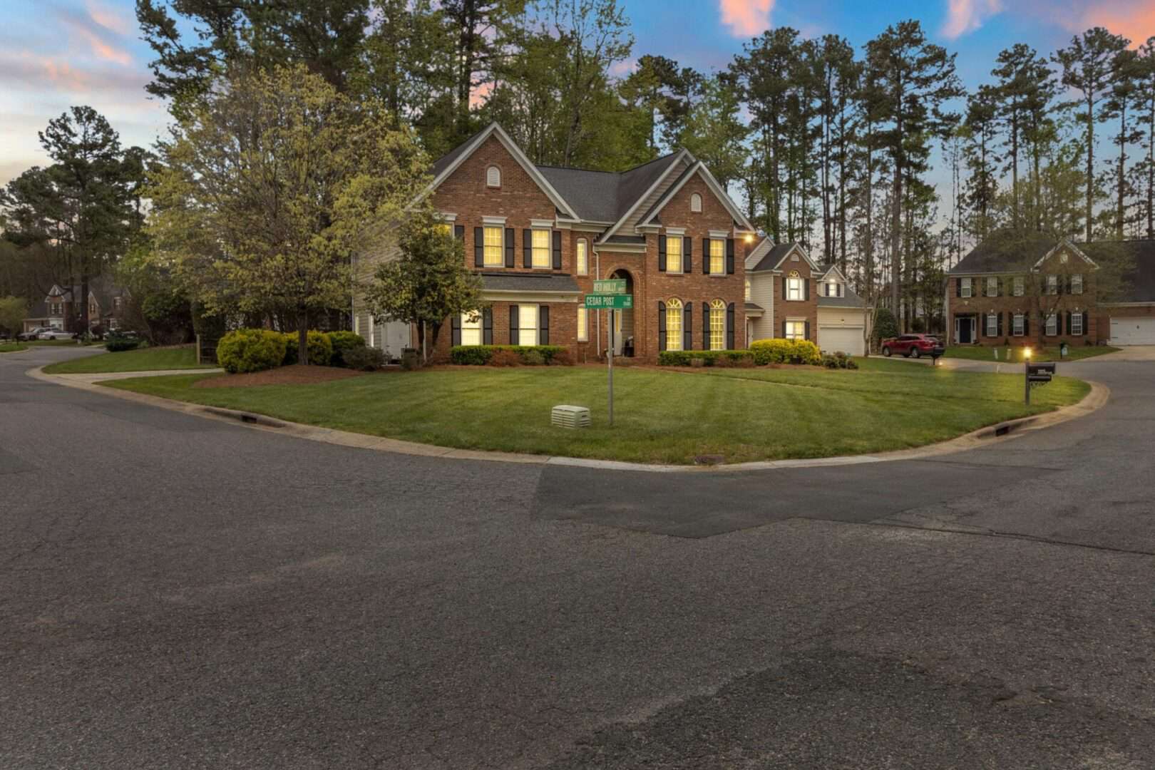 A home with a driveway in the middle of a wooded area.