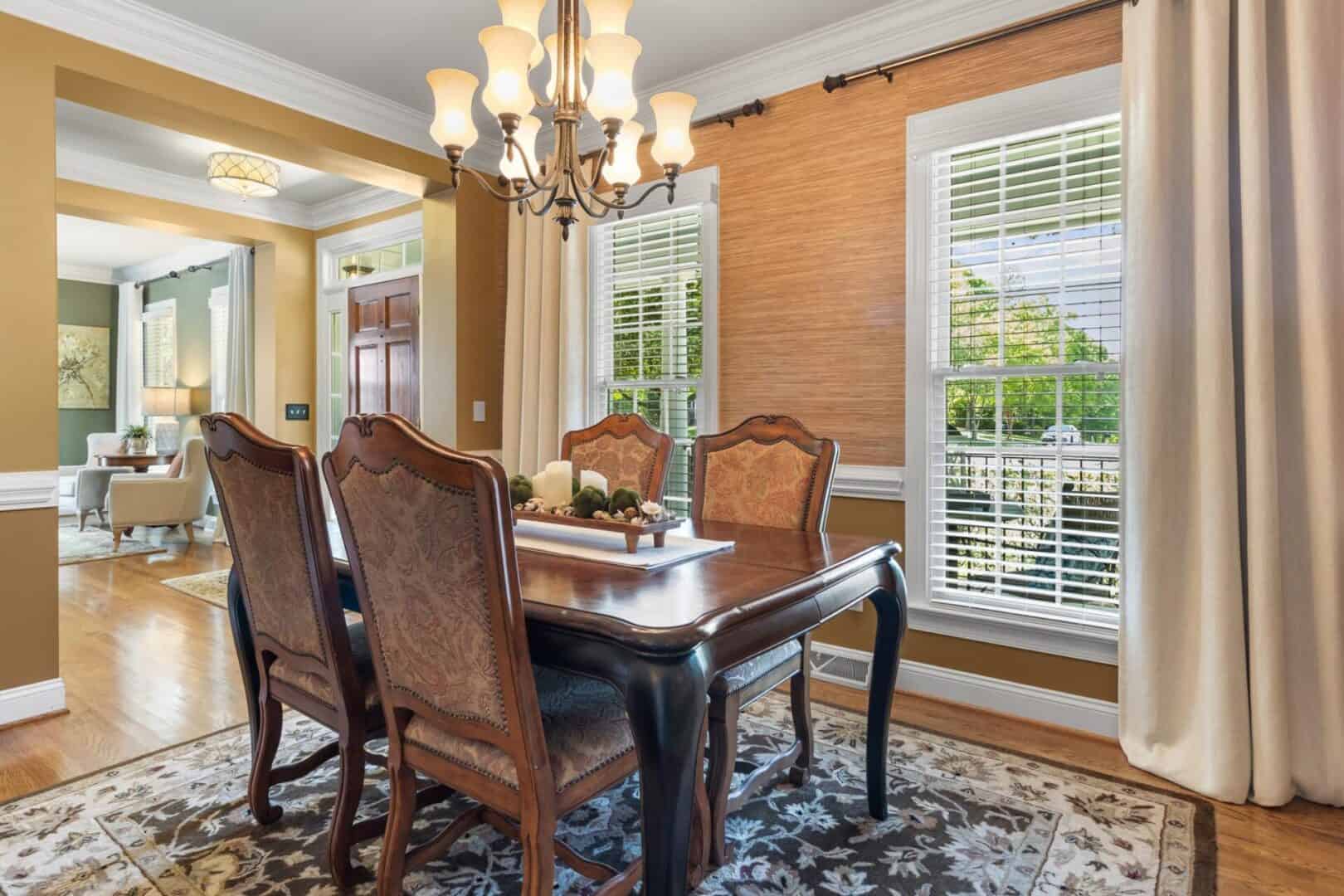 A dining room with hardwood floors and a chandelier.