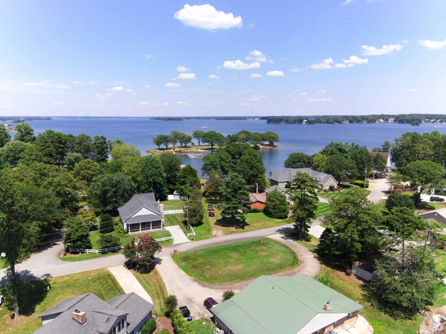 An aerial view of a lake and houses.