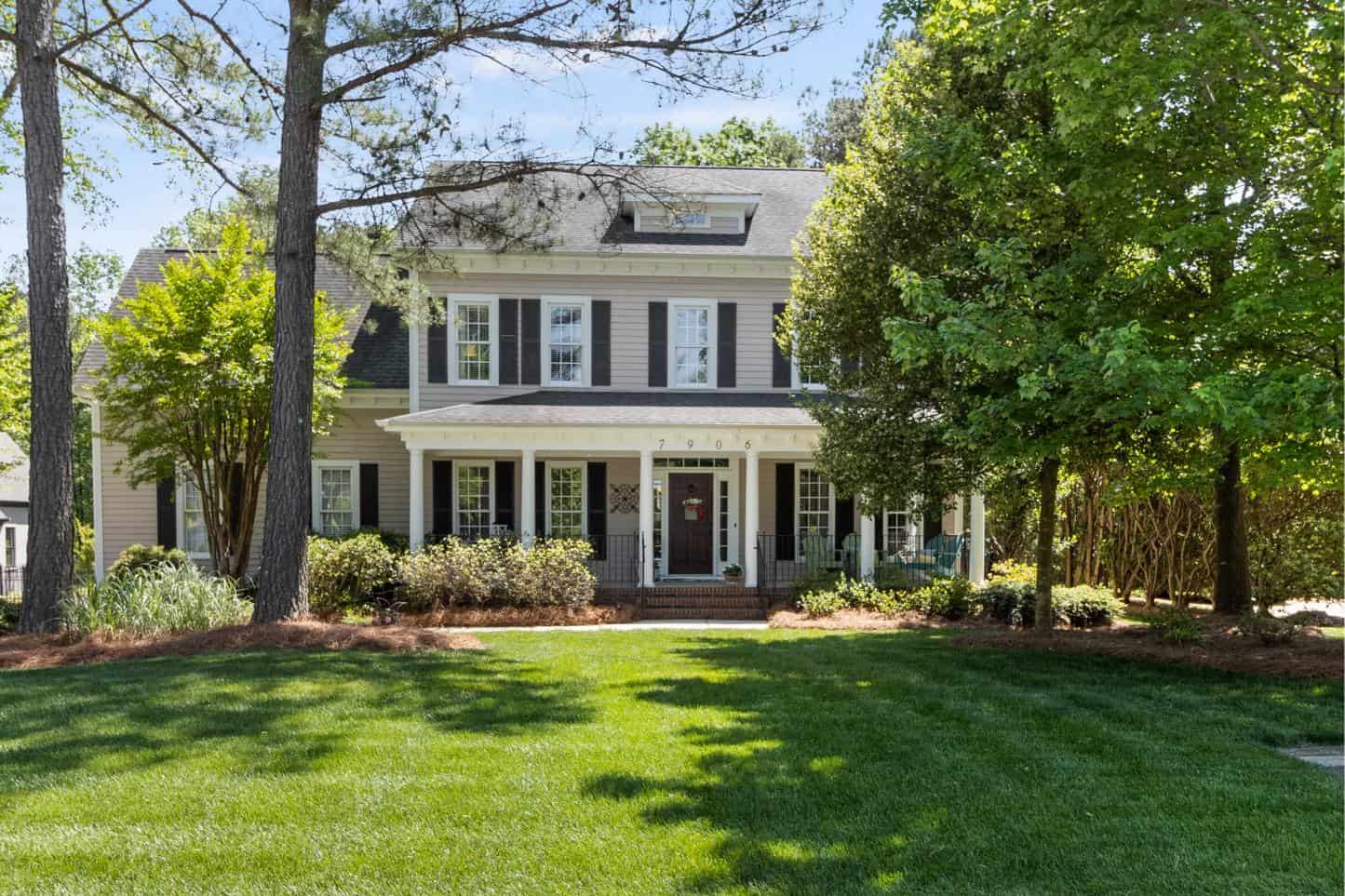 A home with a large front yard and trees.